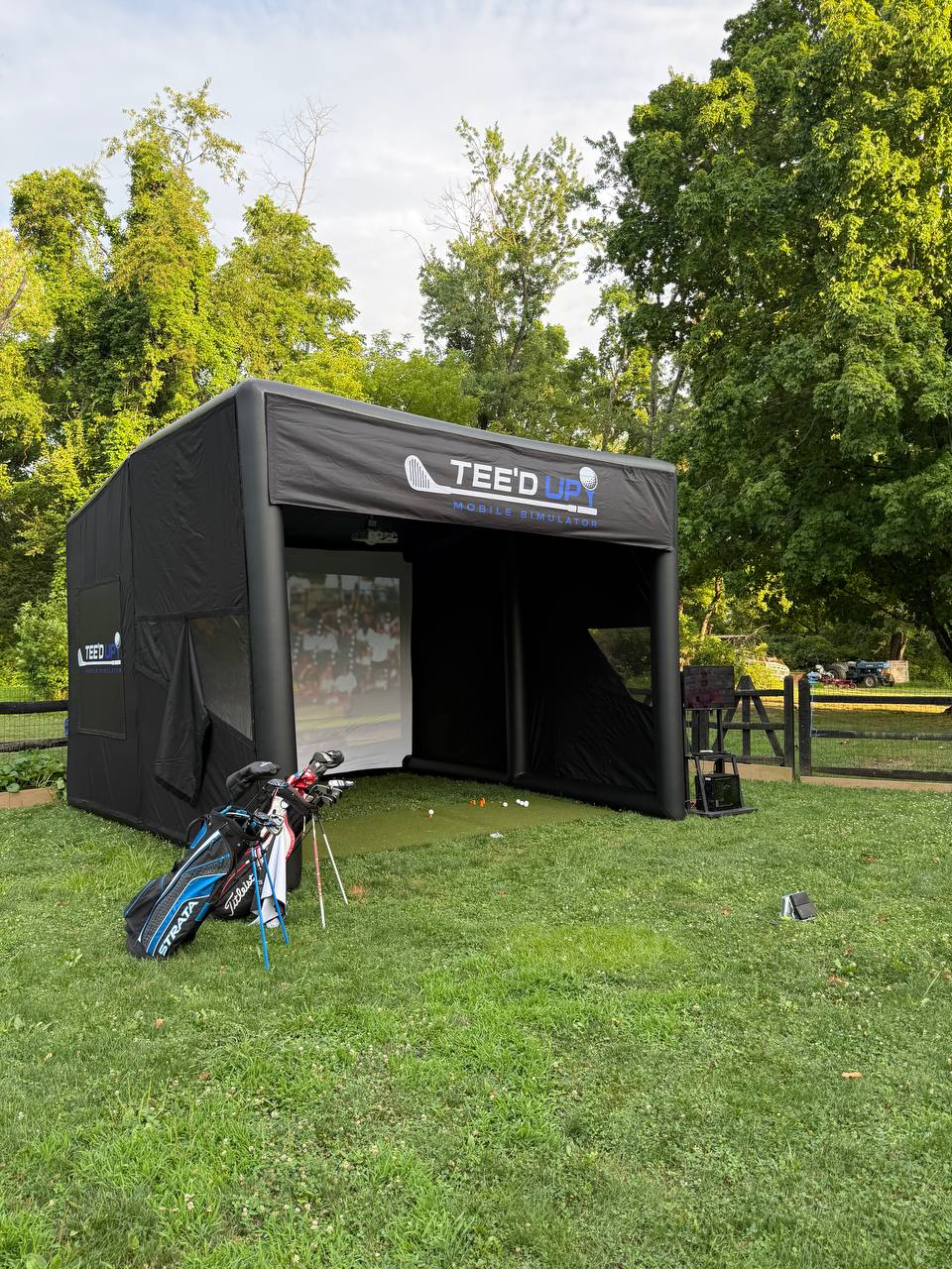 Event setup angle showing the Tee’d Up enclosure and hitting area